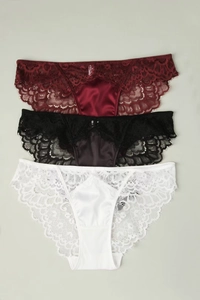 Detailed macro view of three lace panties in burgundy black and white with floral patterns
