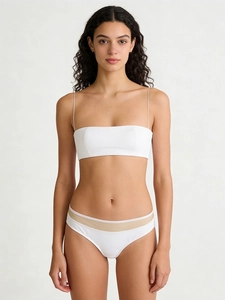 Detail of white thin strap wireless bra with nude mesh paneling and seamless elastic fabric