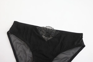 Detail of black sheer mesh panties with floral lace embroidery and elastic edges