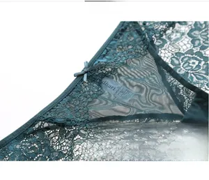 Detail of teal lace underwear featuring floral embroidery and a small bow decoration