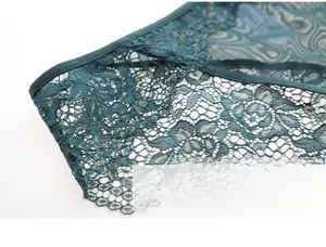 Detailed macro view of dark green floral lace and breathable mesh fabric with L-size tag