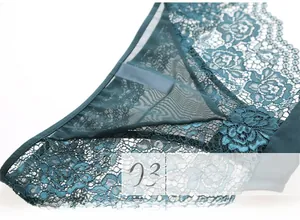 Detail view of semi-transparent floral lace and mesh fabric on green sexy panties