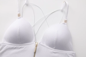 Detail of white triangle bralette featuring front gold zipper and rhinestone accents