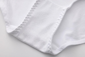 Macro detail of the white cotton panty gusset with premium zigzag stitching finish