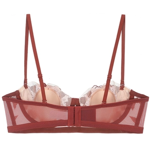Detail view of brick red lace bra featuring adjustable straps and breathable mesh side wings