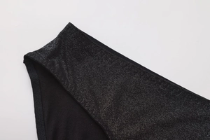 Detail of black sequined bra with shiny silver glitter fabric and smooth knit lining