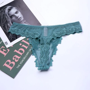Detail view of teal lace thong featuring floral patterns and breathable mesh texture