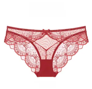 Detail of red floral lace panties with a delicate bow and semi-transparent mesh texture
