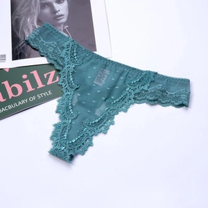 Close-up of sheer blue lace thong with polka dot mesh and delicate wave embroidery