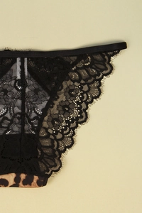 Close-up of sheer black floral lace with eyelash trim and leopard print fabric detail