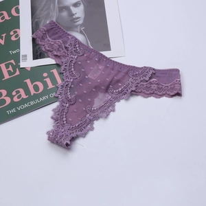 Detailed close-up of purple lace thong with polka dot mesh and delicate embroidery