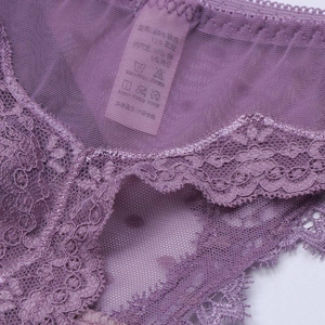 Detail of purple lace thong showing fine floral embroidery and breathable mesh texture