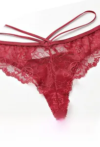 Detailed macro view of burgundy floral lace fabric and sexy hollow strappy waist design