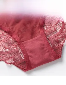 Detailed close-up of dark red hollowed-out lace and breathable mesh on women's briefs