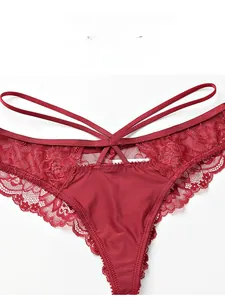 Detailed macro view of dark red lace texture and multi-strap cross design on low waist panties