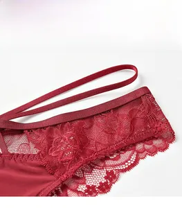 Detailed macro view of dark red floral lace texture and breathable silk fabric on panties