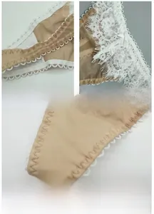 Detail view of breathable beige lace panties with antibacterial cotton lining and bow decor