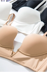 Flat lay of seamless deep V push up bras in beige, white and black smooth fabric
