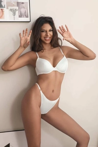 Detail of white satin lingerie set with push-up bra and golden metal buckles