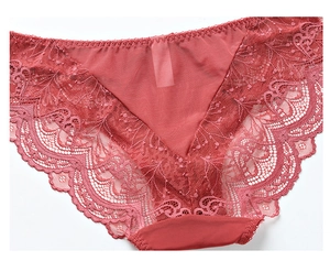 Detail of coral red lace panties featuring intricate floral patterns and sheer texture