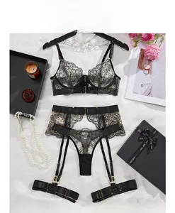 Flat lay detail of black lace lingerie set with garters and gold metal hardware