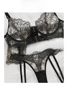 Detail of black eyelash lace lingerie with metallic front closure and embroidery
