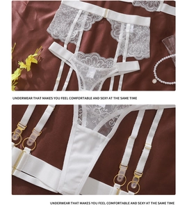 Detail of white eyelash lace lingerie set featuring metal adjusters on brown satin