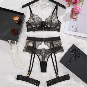Elegant four-piece black lace lingerie set with floral embroidery and gold accents