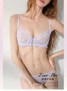 Detailed view of lavender lace bra with delicate floral embroidery and cross strap design