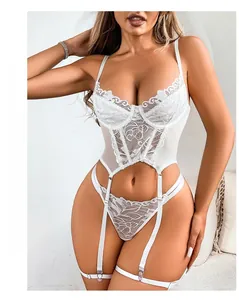 Close-up of intricate floral lace patterns and sheer mesh details on white lingerie set