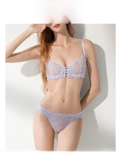 Detailed close-up of light purple floral lace bra set with cross strap embroidery detail