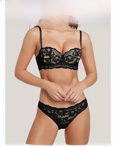 Detail of black floral lace embroidery on half-cup bra and matching panty set