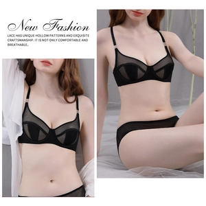 Close-up of black mesh lace lingerie set with silver ring details and geometric cutouts