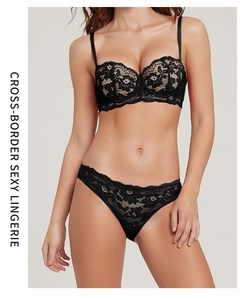 Close-up detail of black floral lace embroidery on push-up bra and matching panty set