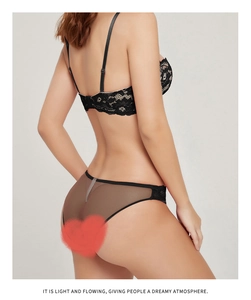 Rear view of black lace bra and mesh panties showing delicate floral embroidery detail