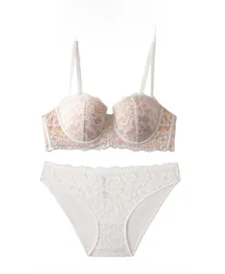 Detail view of white floral lace lingerie set with underwire bra and matching panties