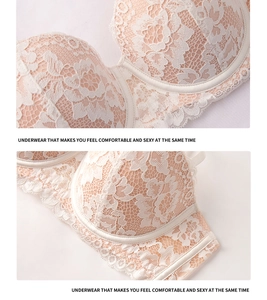 Detailed macro view of the intricate white floral lace embroidery on the beige bra cups