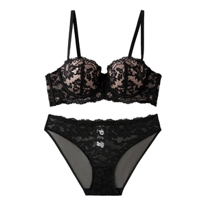 Lace push-up strapless bra and panty set with black floral patterns on nude base