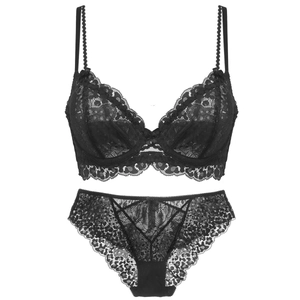 Detail of elegant black floral lace lingerie set with sheer underwired bra and panties