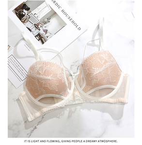 Dettaglio reggiseno in pizzo avorio con ricamo floreale e doppie spalline sottili