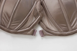Detailed close-up of front-closure buckle and sheer mesh fabric with support stitching