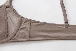 Detail view of brown mesh lace splicing and adjustable straps on seamless bra wings