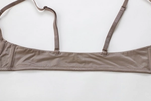 Detail of adjustable straps and seamless wide side wings on a mocha brown lingerie bra