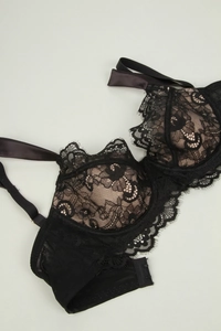 Close-up of black eyelash lace bra with nude lining and multi-row hook-and-eye closure