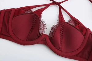 Detail of burgundy satin lingerie with delicate eyelash lace and underwire cup structure