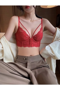 Detailed macro of red floral lace bralette with front clasp and cross strap design
