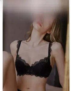 Detail view of elegant black floral lace bra featuring scalloped edges and delicate mesh