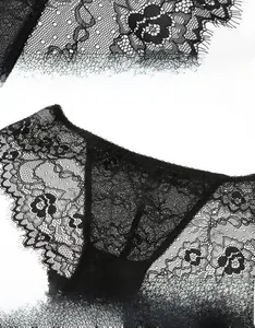 Close-up of black floral lace panties featuring intricate eyelash lace and sheer mesh detail