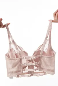Detail showing the cutout back design and adjustable lace straps of a pink bra