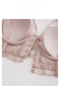 Detailed close-up of pink lace bra featuring a convenient multi-hook front closure design